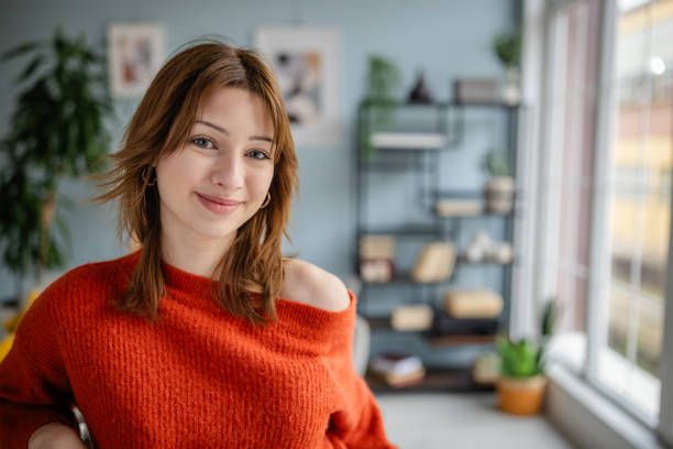 istock Relaxed woman enjoys sunlight by window with decor 2191464579