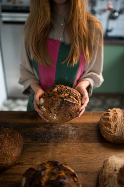 istock Baker holding freshly baked sourdough bread in hands 2191469681