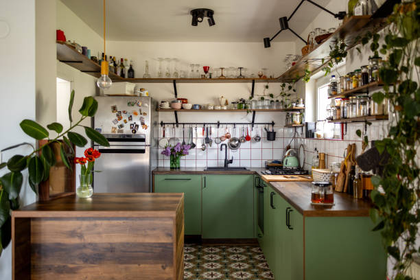 istock Cozy green kitchen interior with open shelving displaying plants and kitchenware 2191469702