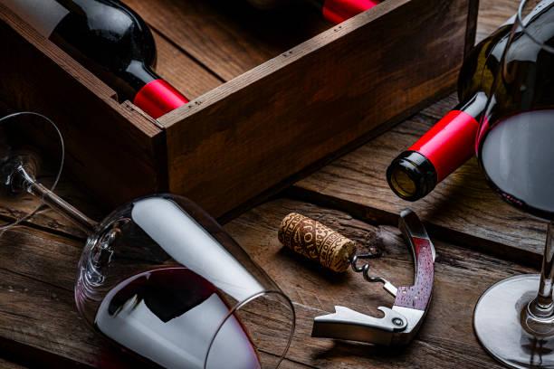 istock Red wineglass and bottles, Rioja cork stopper and corkscrew on rustic wooden table 2191472879