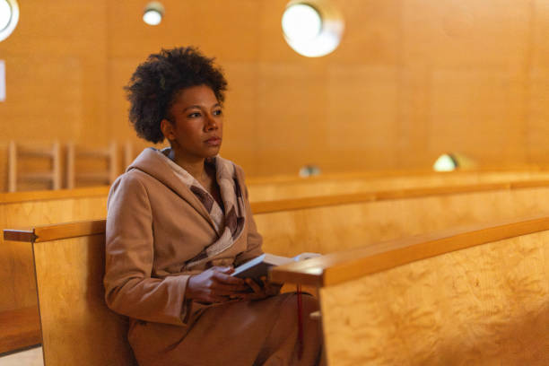 istock Woman in church 2191476009