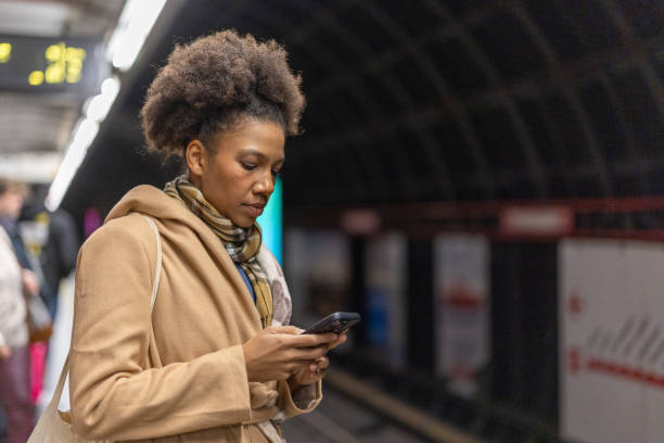 istock Woman using the phone at subway station 2191476057