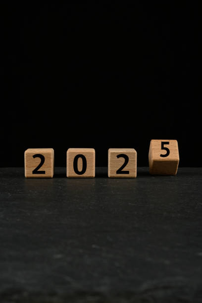 istock 2025 in text on wooden cubes on black background 2191477223