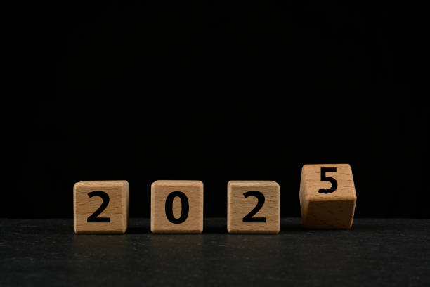 istock 2025 in text on wooden cubes on black background 2191477225