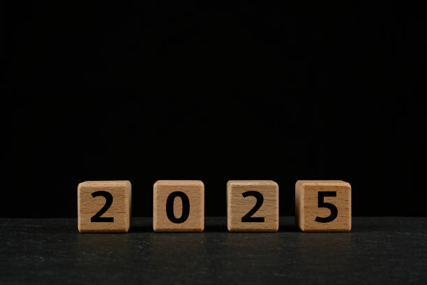 istock 2025 in text on wooden cubes on black background 2191477226