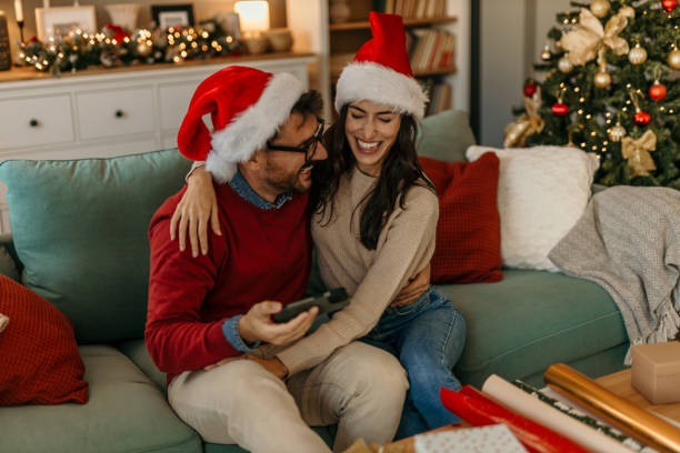 istock Couple using phone on Christmas day 2191477557