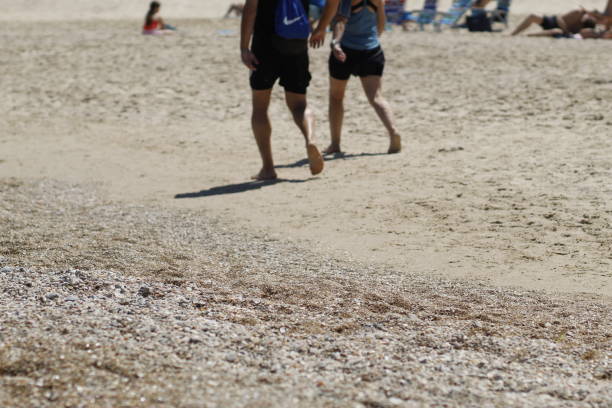 istock people's feet in the sand on the beach 2191480188