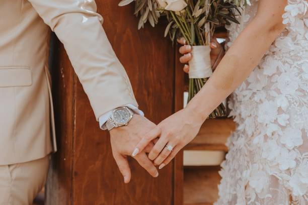istock Bride and groom holding hands 2191480524