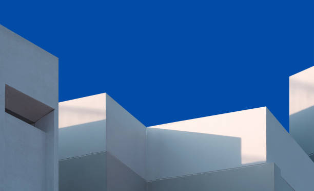 istock Modern house Building with light and shadow on white and gray concrete wall surface against blue clear sky background 2191481403