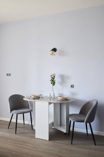 istock Discover a Stylish Minimalist Dining Set paired with a Soft Light Purple Wall for elegance 2191483736