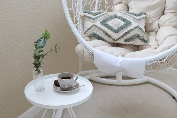 istock A Cozy Modern Chair Featuring a Decorative Pillow and Stylish Coffee Setup Arrangement 2191484310