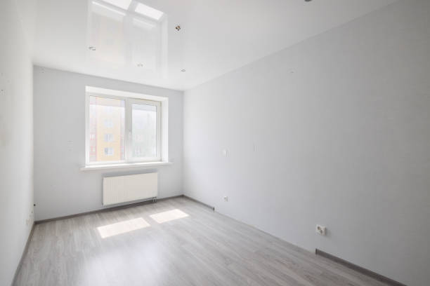 This is a bright and minimalist unfurnished room that features ample natural light pouring in