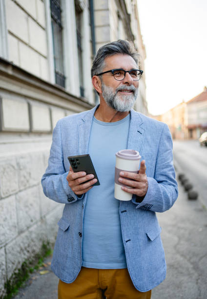 istock Man with smartphone walking on the street 2191486219