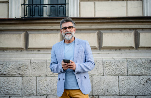 istock Mature man using phone outdoors 2191486300