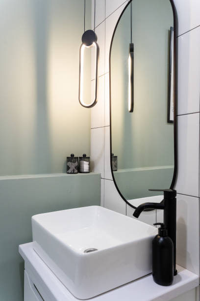 istock Explore the latest in modern bathroom design featuring an elegant sink combined with stylish lighting for a sophisticated ambiance 2191487260