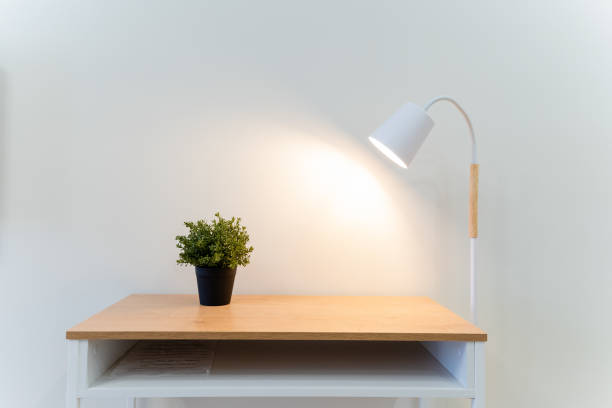 istock A wellorganized desk boasts a bright lamp that provides ample light for tasks and a charming potted plant sitting atop it, together creating a pleasant and inviting workspace atmosphere 2191487289