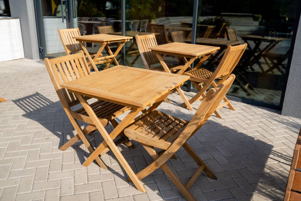 istock A beautiful wooden table accompanied by matching chairs is placed perfectly on a charming brick patio, creating an inviting outdoor dining area for relaxation and enjoyment 2191487368