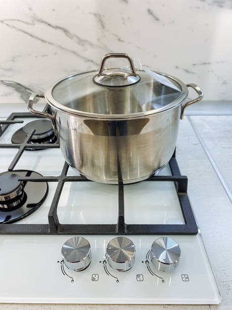 istock A pot filled with water is currently cooking on a gas stove, which is a common kitchen appliance that is essential for heating and preparing a wide variety of foods in culinary arts 2191487400