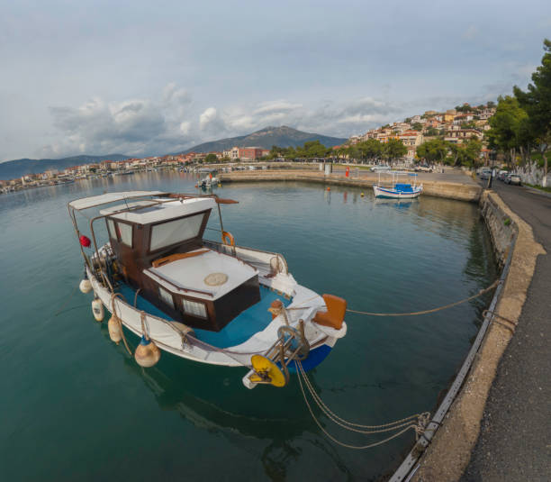 Fishing boats in Astros Harbour (Astros Paralio), Peloponnese Greece. Village in the background