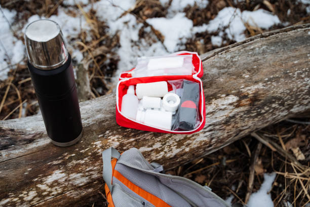 istock A first aid kit is sitting on a log next to a backpack and a thermos 2191489567