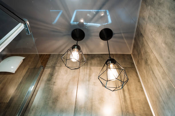 istock In the beautifully inviting bathroom, two elegantly stylish pendant lights are gracefully hanging from the ceiling, which significantly enhances the warm and cozy atmosphere of the space 2191489609