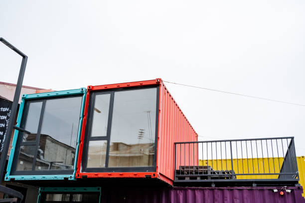 istock A vibrant and colorful shipping container that features a spacious balcony situated elegantly on its upper portion, adding a unique architectural touch to its design and usage 2191489647