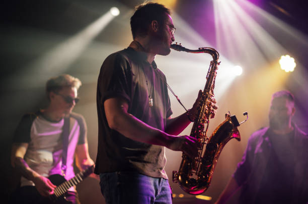 istock Saxophonist performing live on stage with band 2191490161