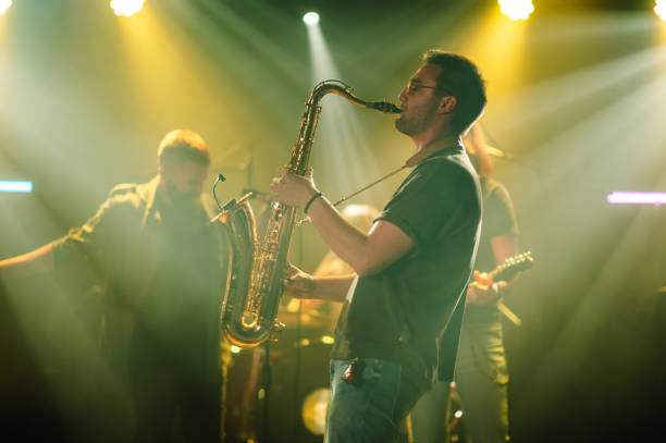 istock Saxophonist performing live on stage with band 2191490168