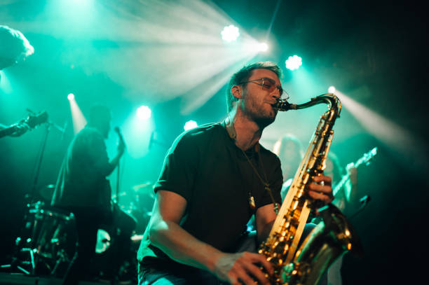 istock Saxophonist performing live with band on stage 2191490176