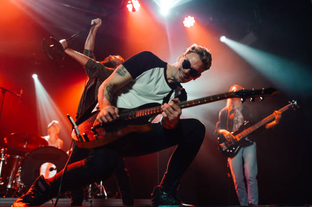 istock Guitarist performing with passion on stage under red lights 2191490181