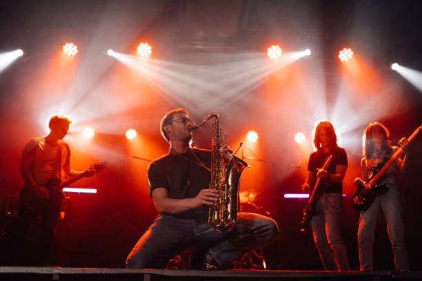 istock Saxophonist performing with band on illuminated stage 2191490191