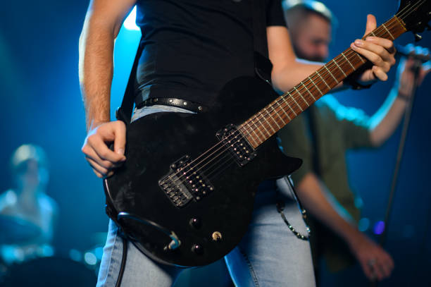 istock Guitarist performing live on stage with band 2191490207