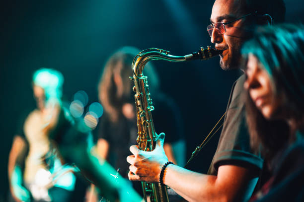 istock Saxophonist performing live with band on stage 2191490229