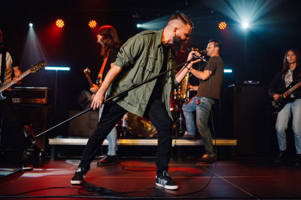 istock Rock band performing live on stage with passion 2191490259