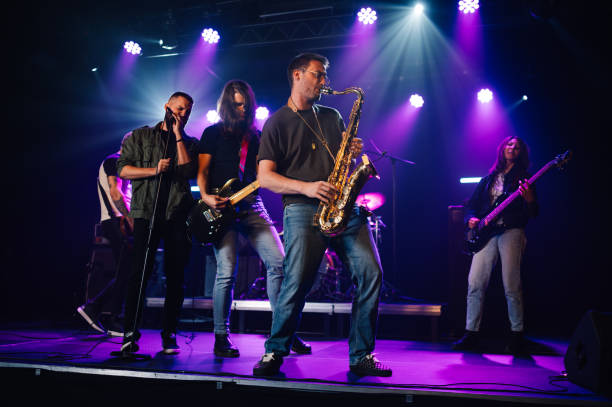istock Music band performing live on stage with purple lights 2191490263