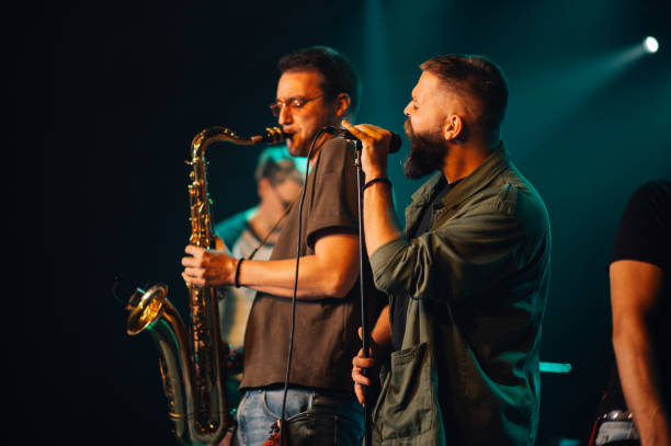 istock Musicians playing saxophone and singing on stage during live performance 2191490265