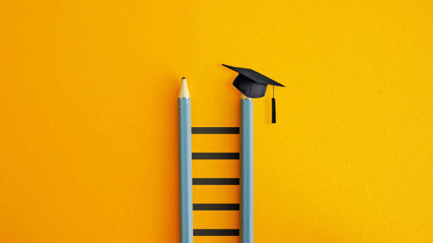 istock Graduation hat on the ladder on an orange background with copy space. Continuing Education and Registered Education Savings Plan RESP. Education loan 2191492434