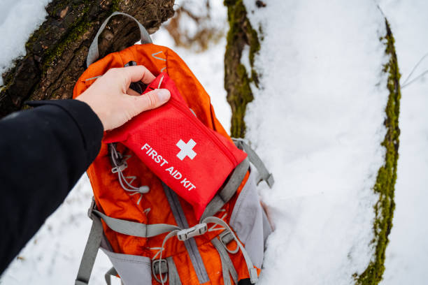 istock A diligent person is carefully packing a wellorganized first aid kit into a sturdy backpack, ensuring all essential supplies for safety during outdoor adventures are included 2191492862