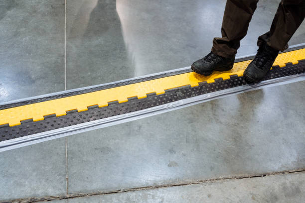 A person is standing on a staircase that features a bold and striking yellow and black pattern, which creates an exciting and vibrant visual contrast that truly captures attention