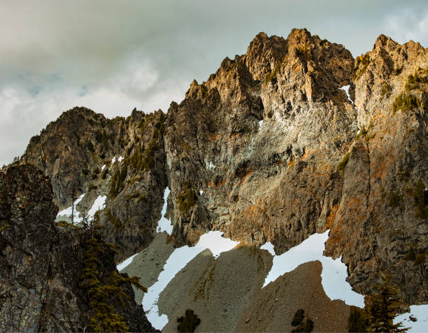 Chair Peak at sunset. Viewed from the trail up to Kaleetan Peak. Chair Peak is a 6238 foot mountain located in North Bend Washington in the Alpine Lakes Wilderness. A technical first summit for any mountaineer. It lies close to other notable peaks such as Kaleetan Peak and a historic peak known as The Tooth.