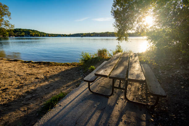 A picnic table sits next to a deserted beach on a Wisconsin lake in early October.