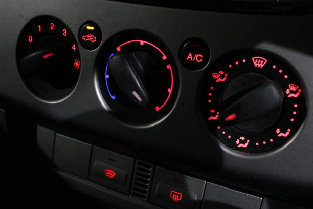 istock Analog climate controls taken from inside car at night, fan control, temperature control and directional control with Air conditioning button 2191505591