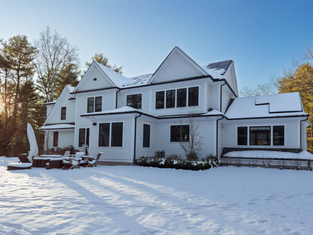 istock Sun goes down on snowy house 2191505729