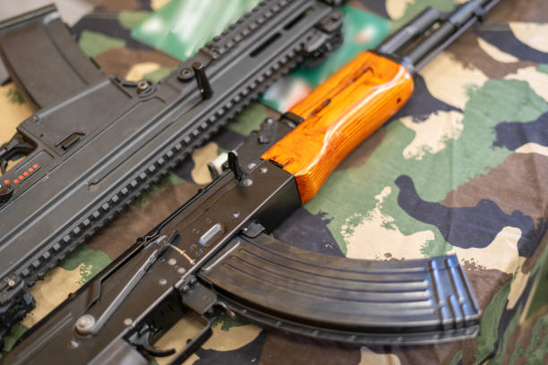 istock AK-47 Kalashnikov and a modern assault rifle on a camouflage tarp 2191507216