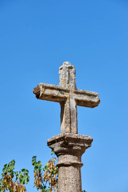 istock Historic Stone Cross on Column Against a Clear Blue Sky 2191511553