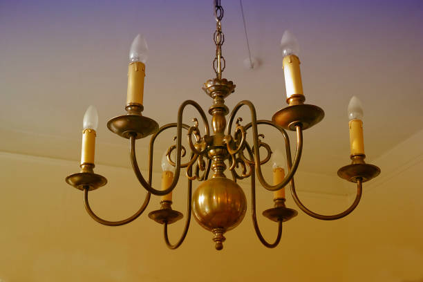 A beautiful brass chandelier featuring candle-shaped bulbs, enhancing the classic and sophisticated interior decor with its vintage lighting style and ornate metalwork.