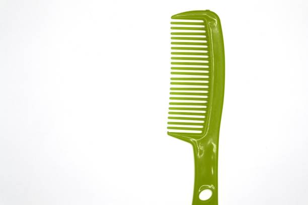 A green plastic comb is isolated against a white background.