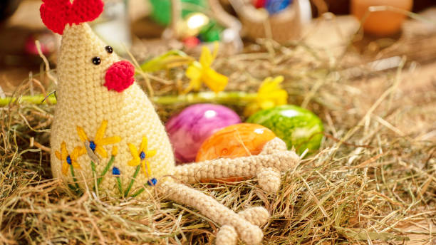 istock Crochet chicken with colorful eggs in straw nest 2191512365