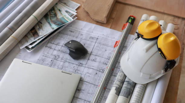 Construction equipment. Home and Building construction , laptop on drawing and safety hardhat at construction site