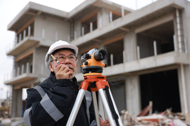 Land surveyor looking through digital level lunette.